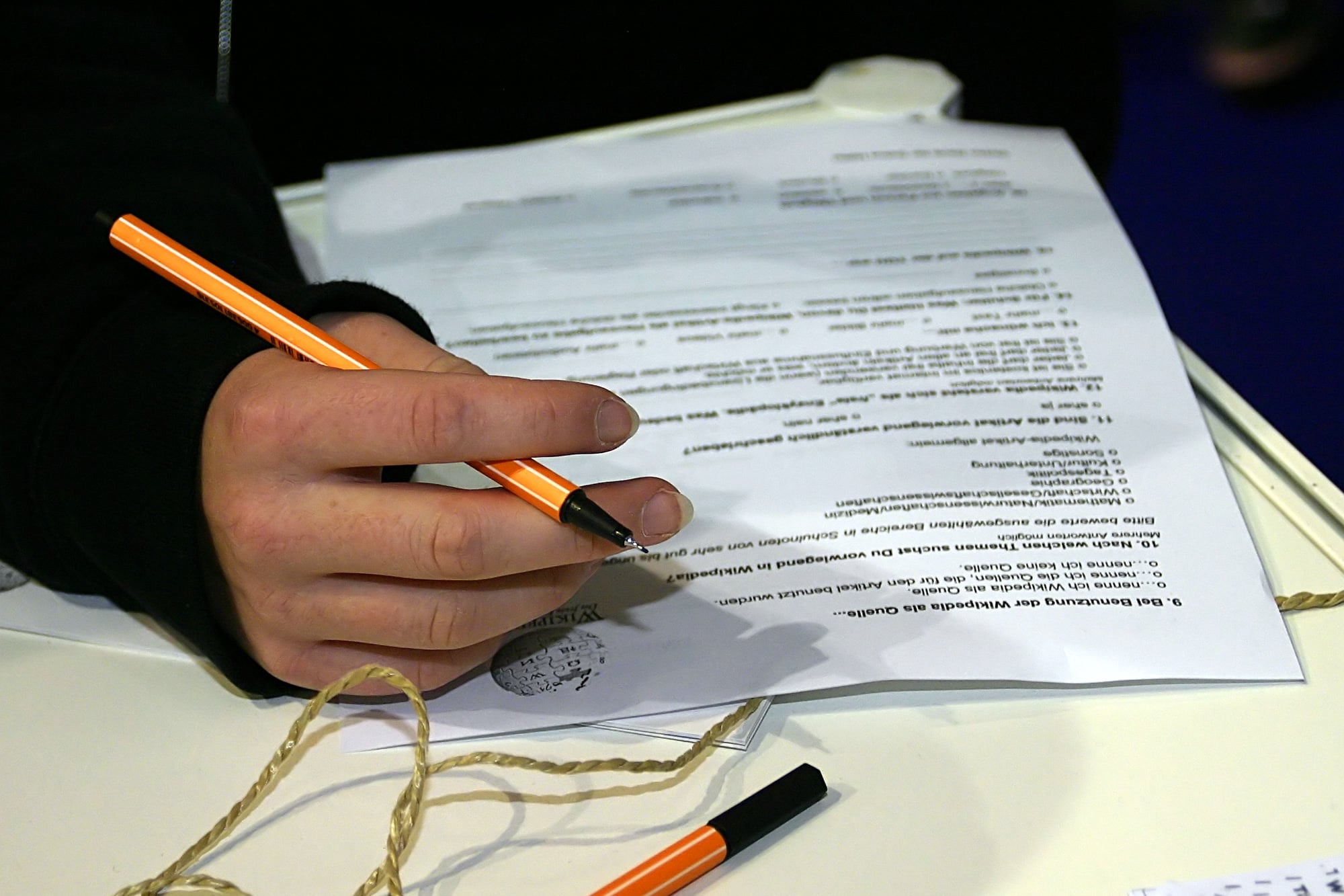 A participant completes a paper questionnaire