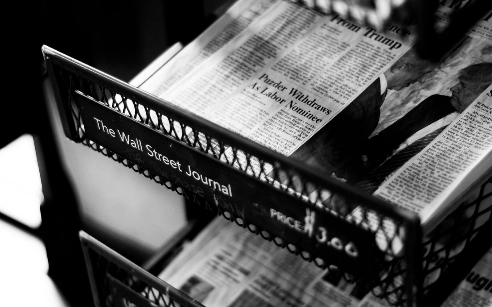 Printed newspapers displayed in a newsstand