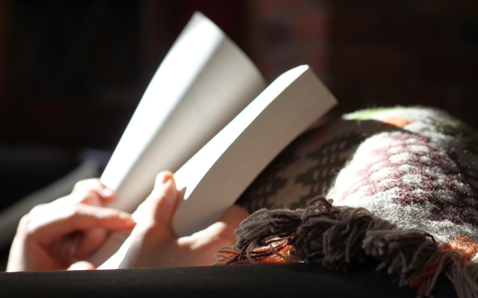 A reader holds an open book