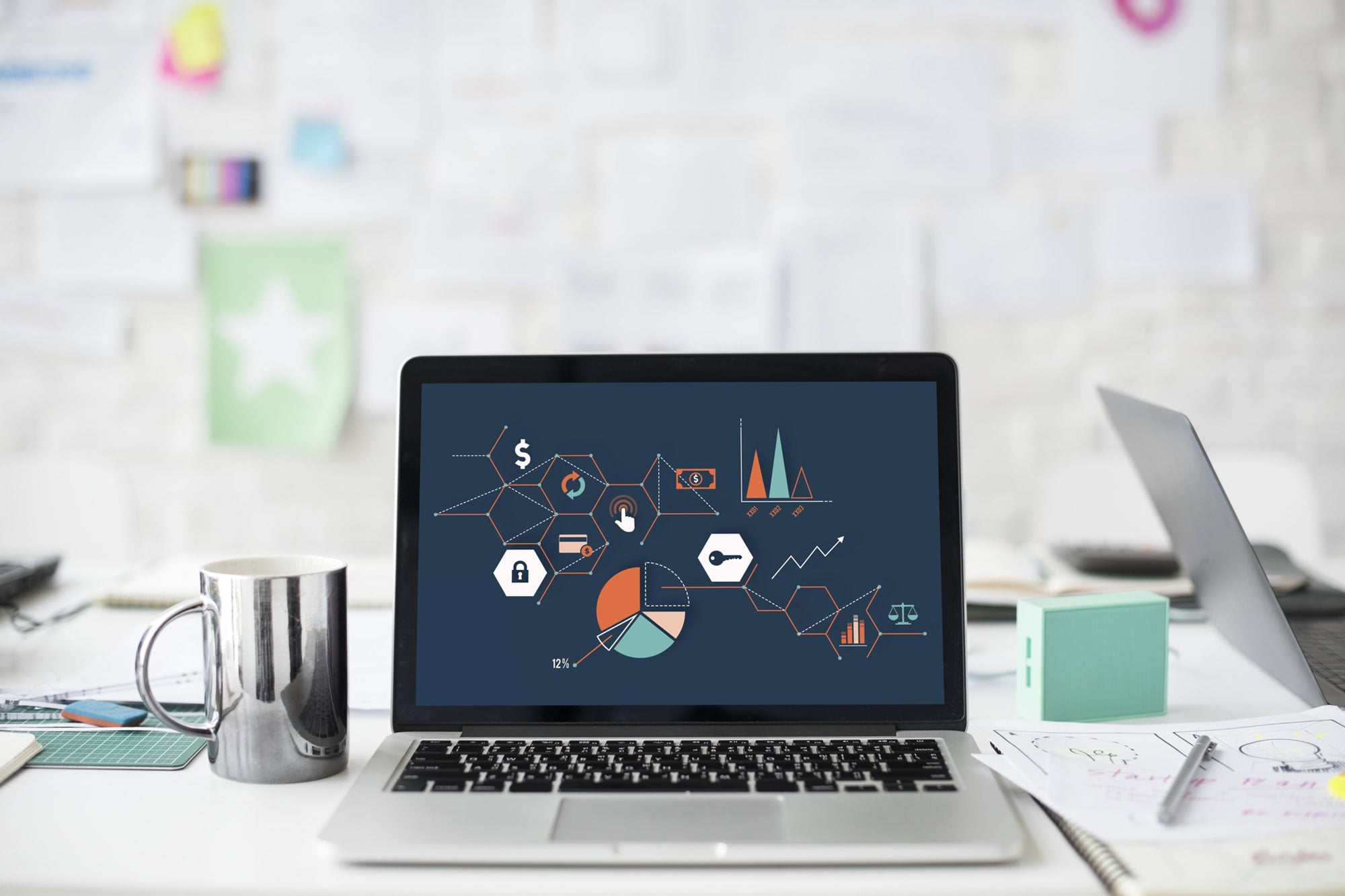 Charts and analytical graphics on a laptop at a work desk
